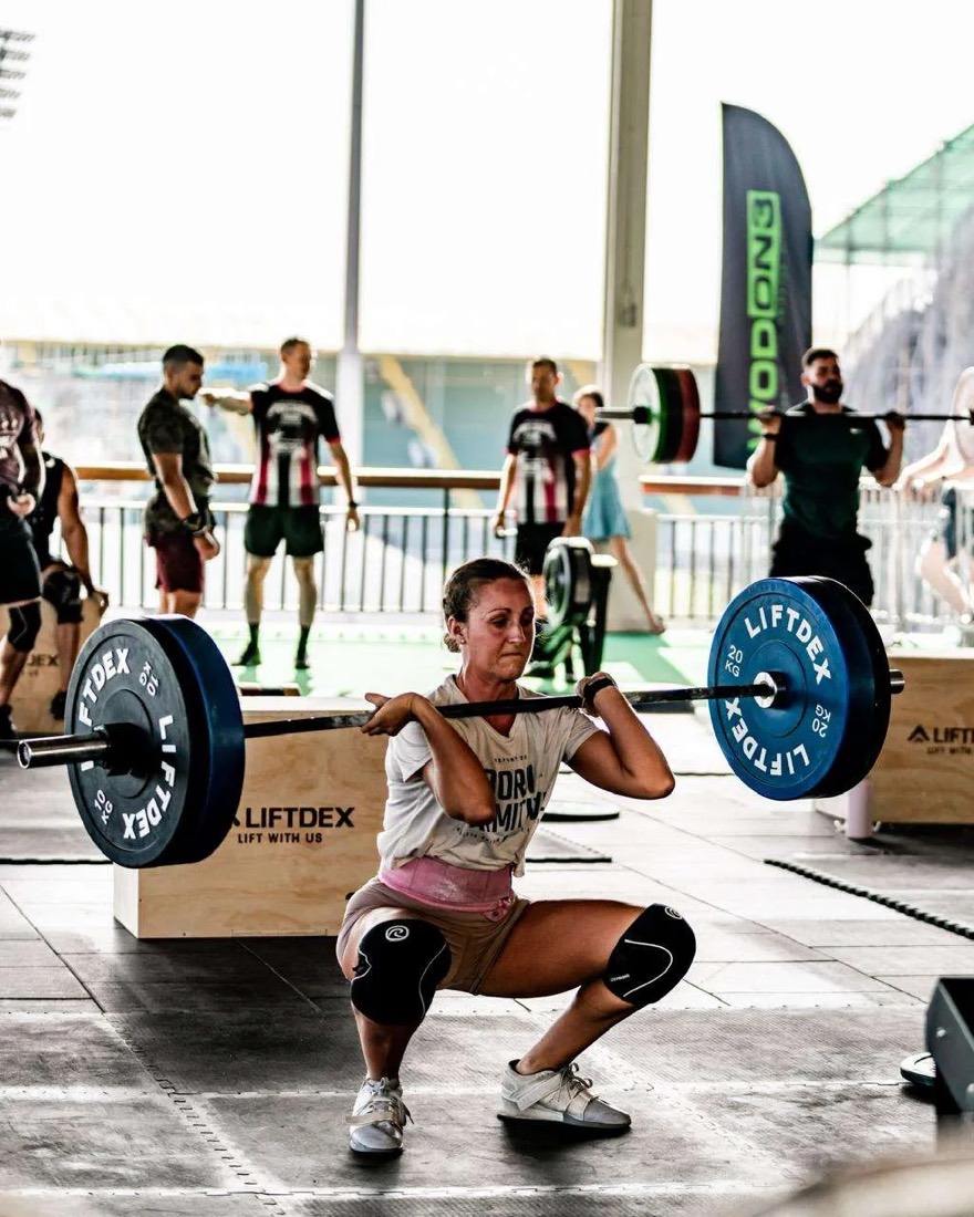 Laura Dacey focused during a front squat at a competition